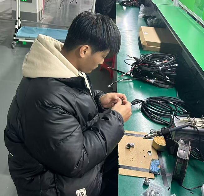 Connector Mating and Unmating Force Test An engineer testing the mating force of an automotive connector